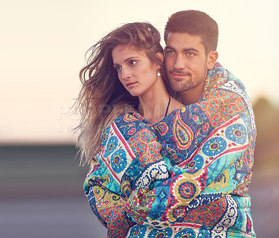 Buy stock photo Shot of an affectionate young couple at the beach