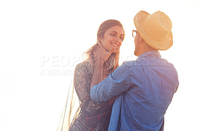 Buy stock photo Shot of an affectionate young couple at the beach