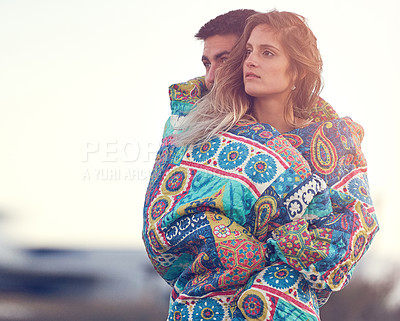 Buy stock photo Shot of an affectionate young couple at the beach