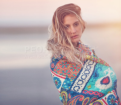 Buy stock photo Cropped shot of an attractive young woman wrapped in a blanket on the beach