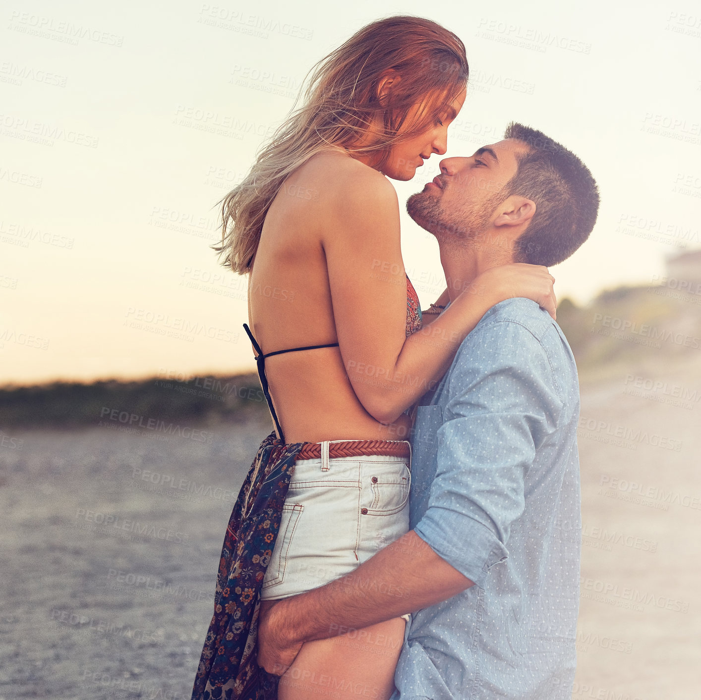 Buy stock photo Couple, hug and lift outdoor with connection, loyalty and bonding together for summer holiday at beach. People, dating and embrace with affection, trust and healthy relationship on romantic vacation.
