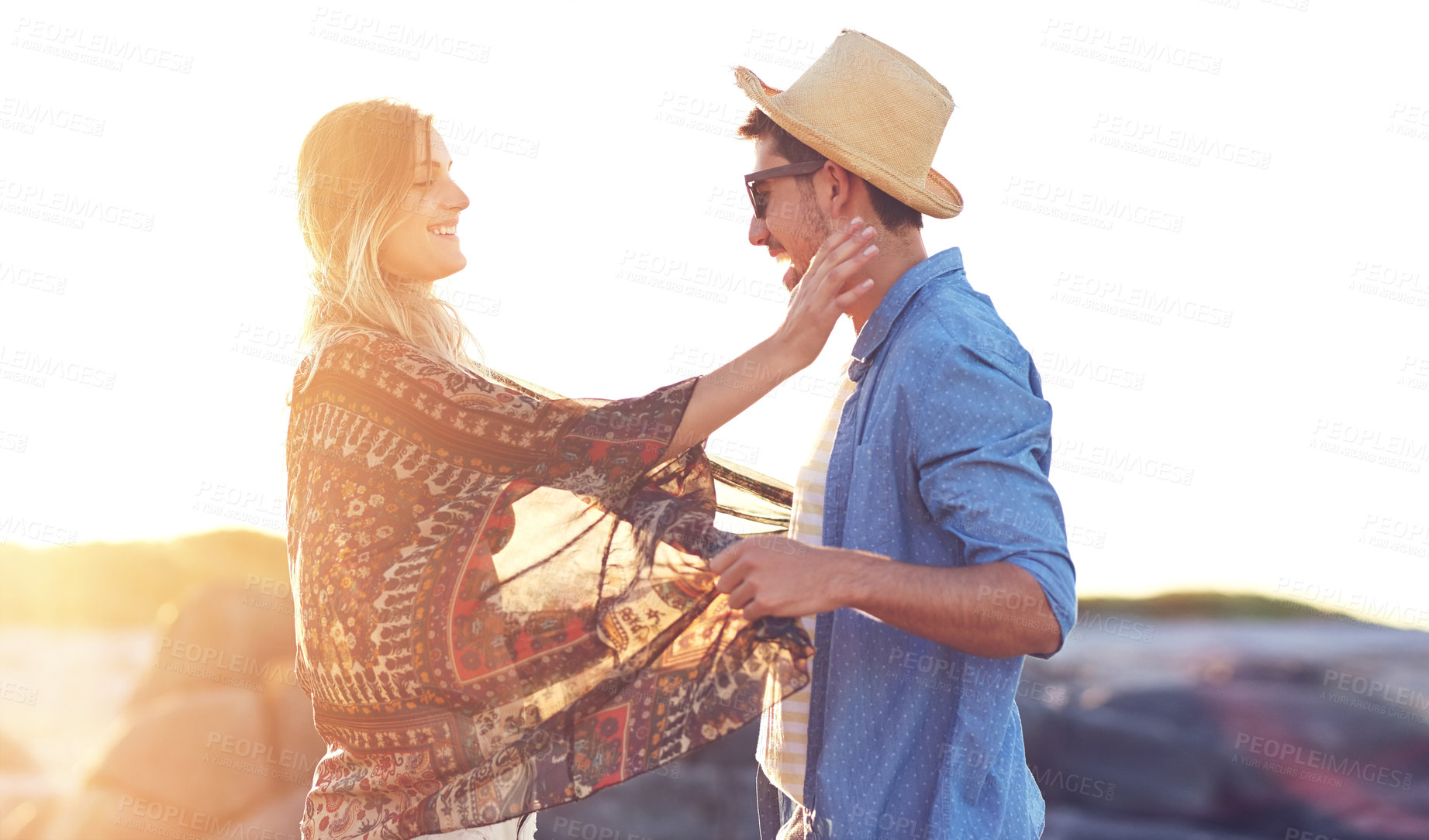 Buy stock photo Shot of an affectionate young couple at the beach