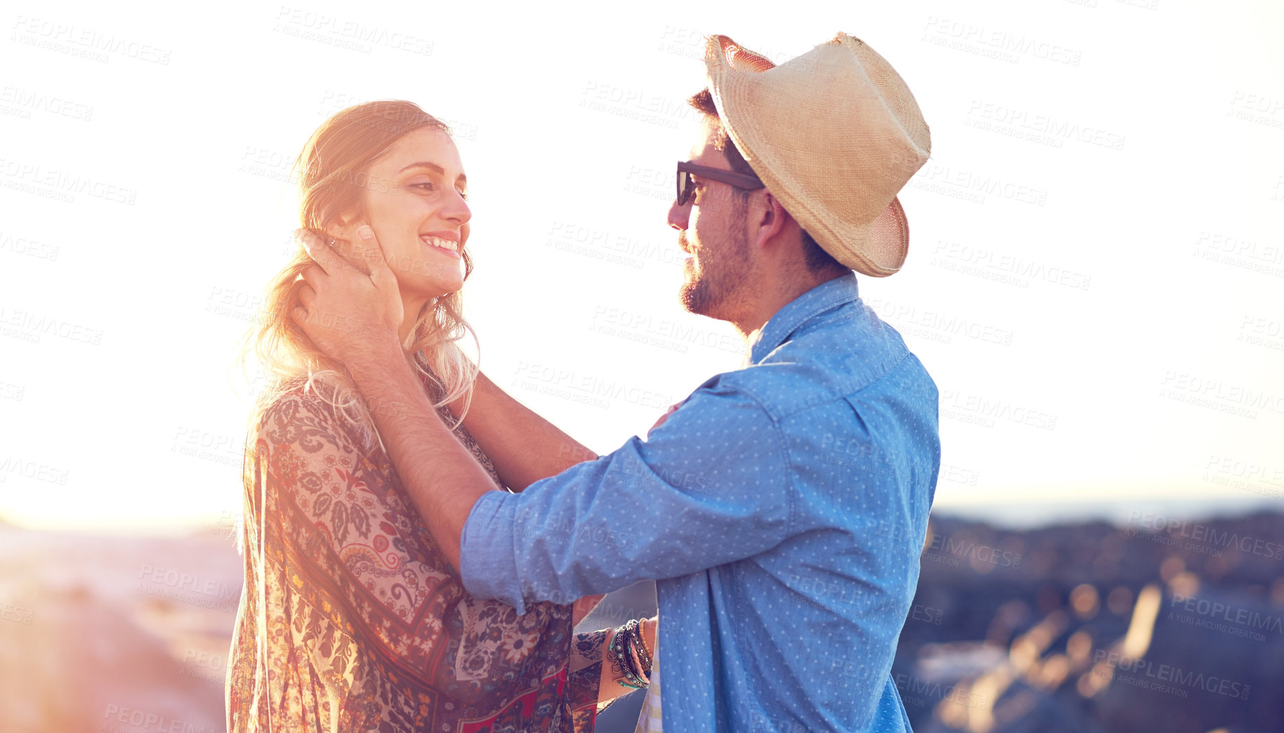 Buy stock photo Shot of an affectionate young couple at the beach