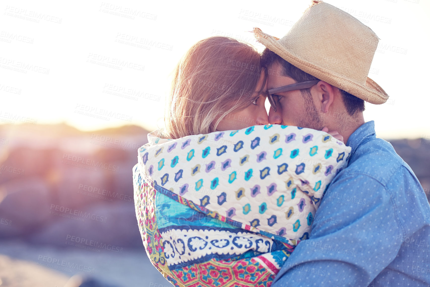 Buy stock photo Shot of an affectionate young couple at the beach