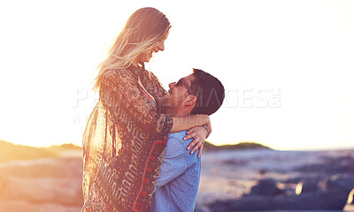 Buy stock photo Shot of an affectionate young couple at the beach