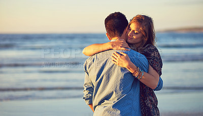 Buy stock photo Shot of an affectionate young couple at the beach