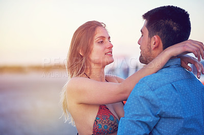Buy stock photo Couple, vacation and hug outdoor with love at the beach for travel, freedom and romantic date. Young woman and a man together on holiday to relax, bond and quality time with affection in nature