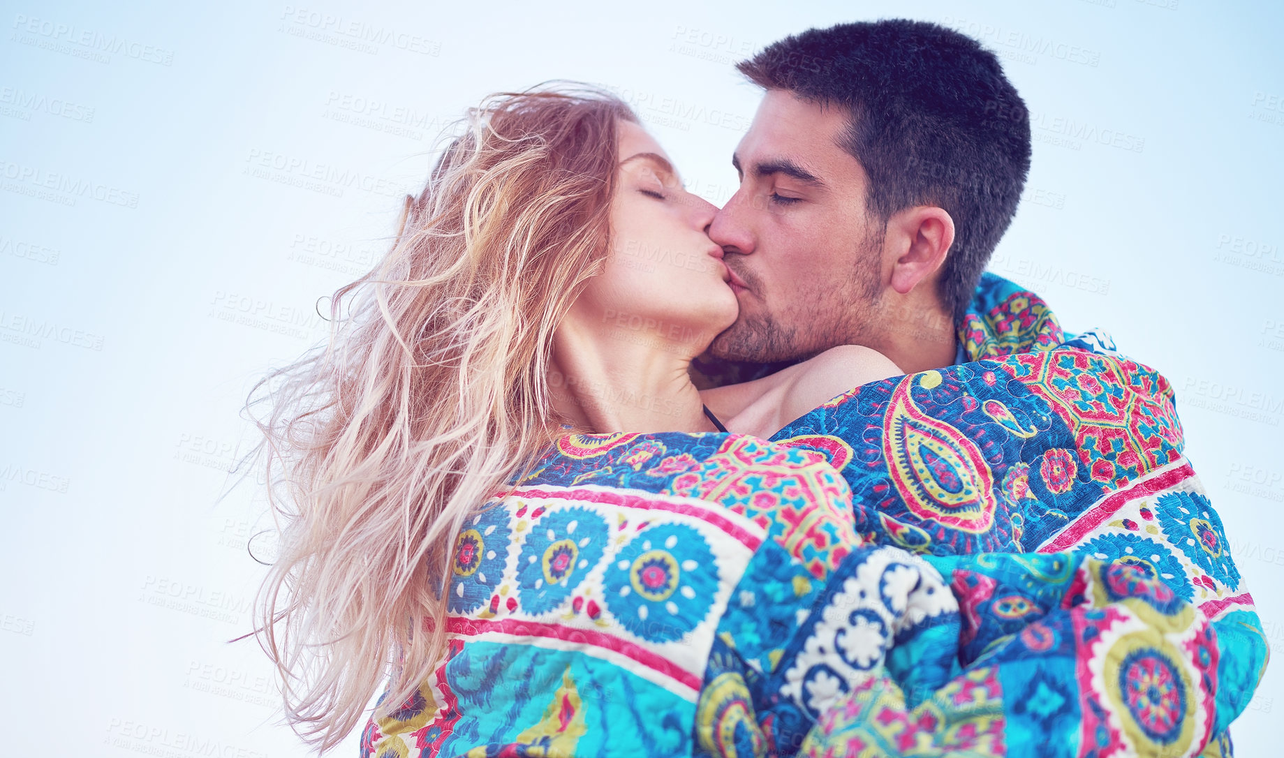 Buy stock photo Shot of an affectionate young couple at the beach