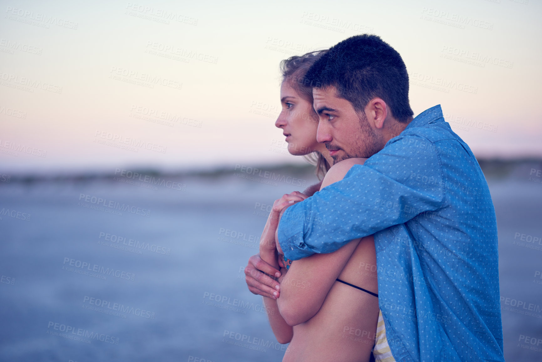 Buy stock photo Shot of an affectionate young couple at the beach