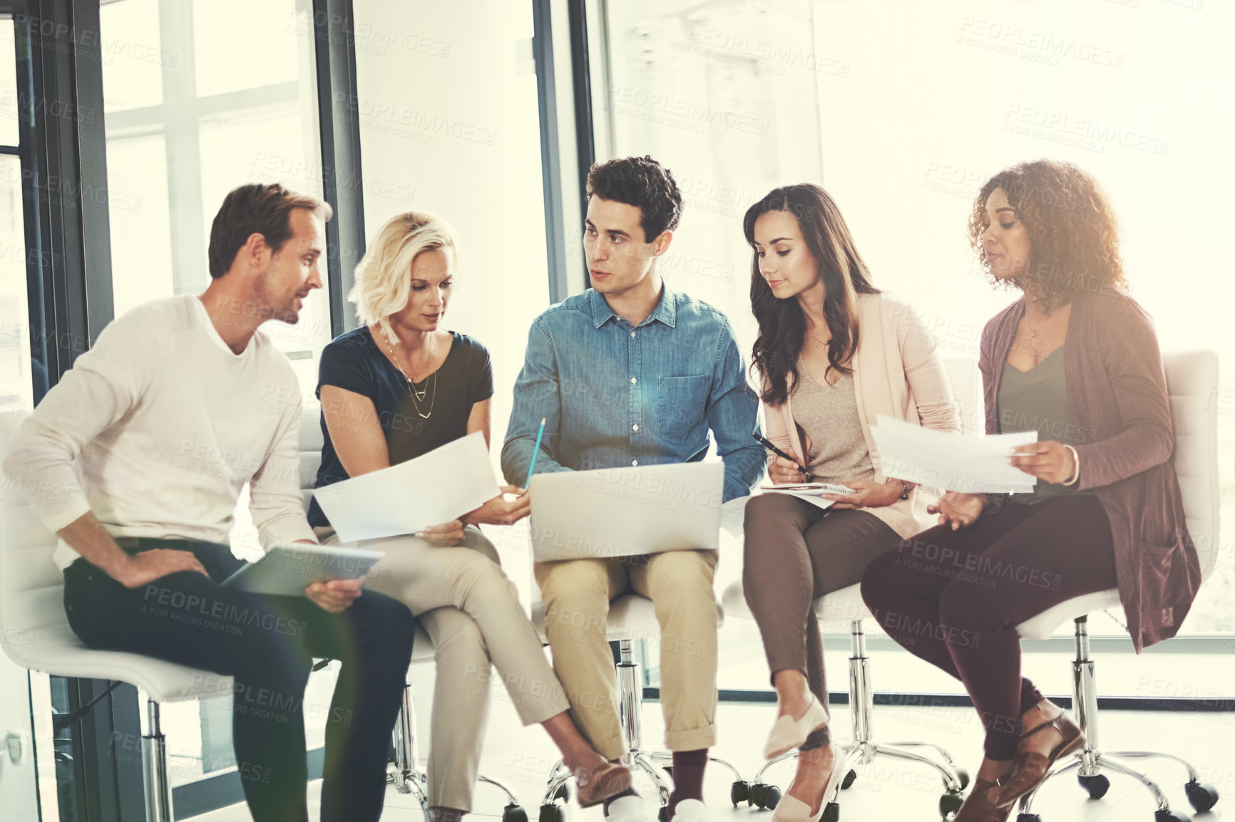 Buy stock photo Shot of a team of designers brainstorming together in an office