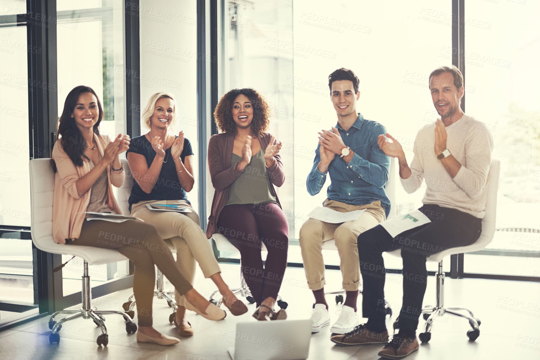 Buy stock photo Portrait of a team of designers applauding together in an office