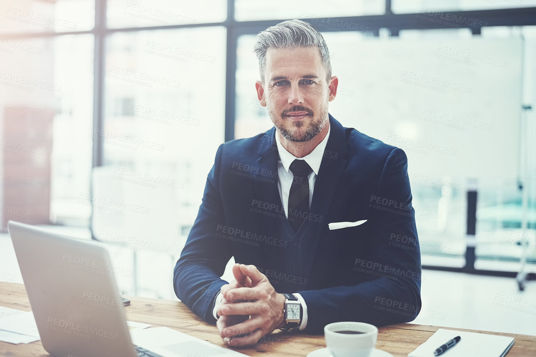 Buy stock photo Portrait of a mature businessman working at his desk in a modern office