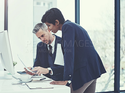 Buy stock photo Shot of a businesswoman and businessman collaborating on a project at work