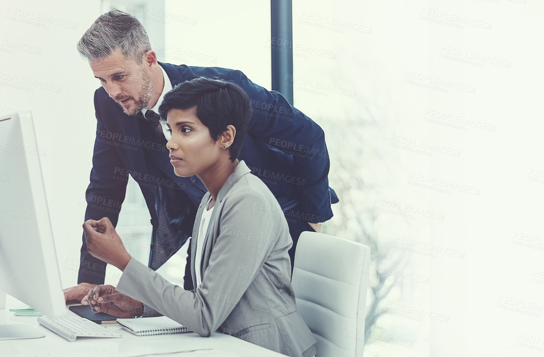 Buy stock photo Shot of a businesswoman and businessman using a computer together at work