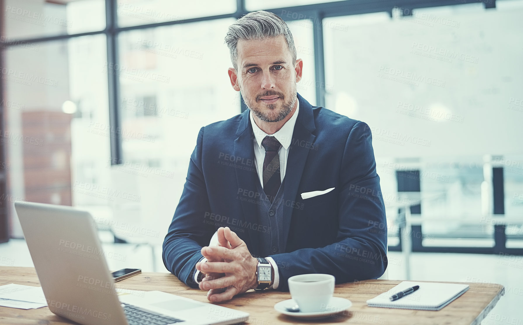 Buy stock photo Portrait of a mature businessman working at his desk in a modern office