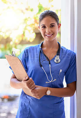 Buy stock photo Portrait of a young medical practitioner holding a clipboard in a hospital