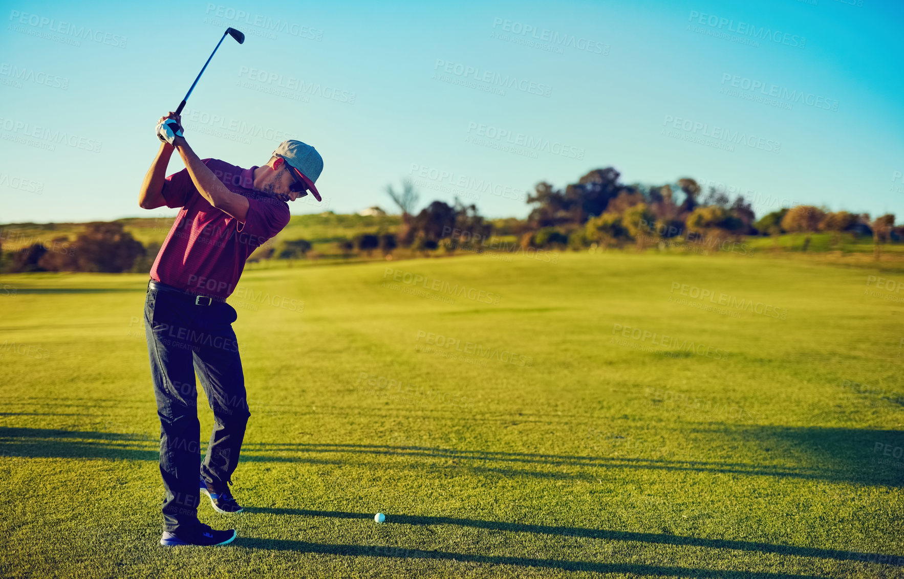 Buy stock photo Shot of a young man playing golf