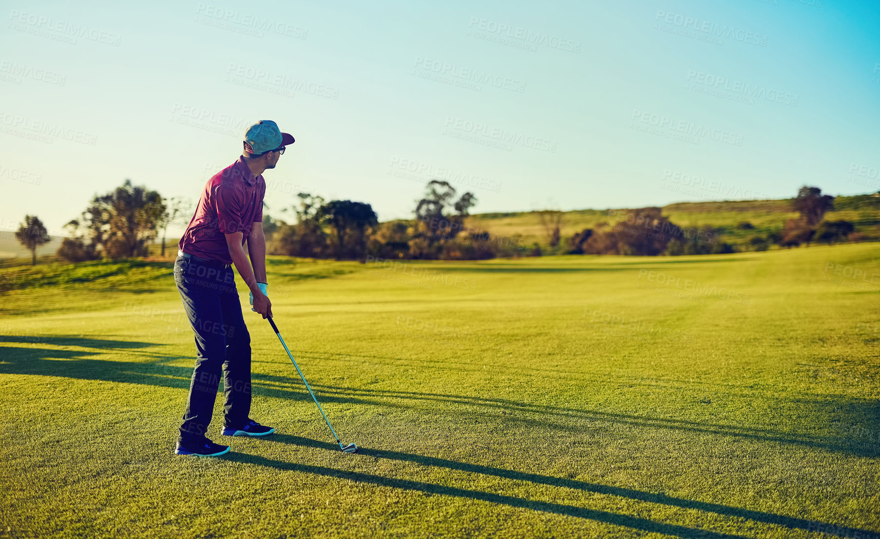 Buy stock photo Shot of a young man playing golf