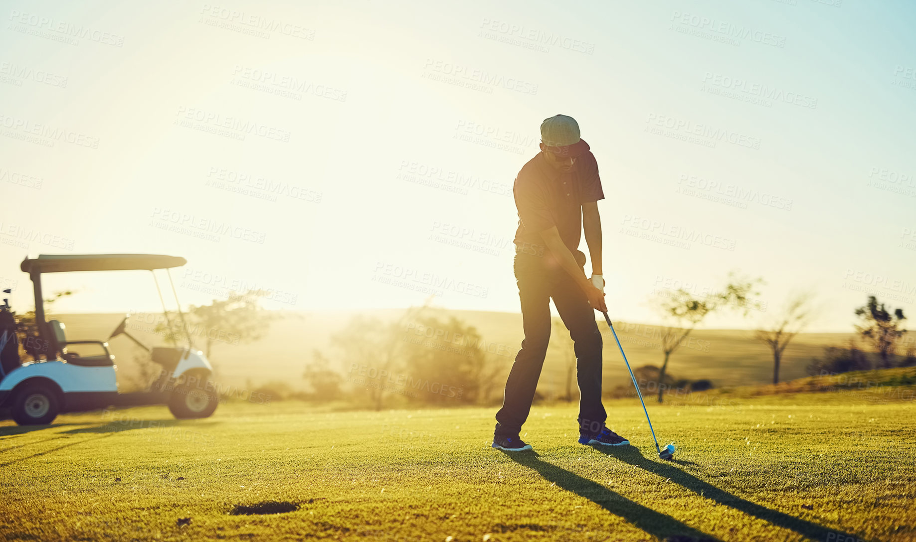 Buy stock photo Shot of a young man playing golf