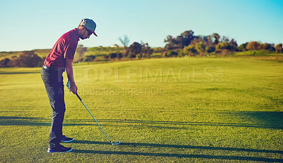 Buy stock photo Shot of a young man playing golf