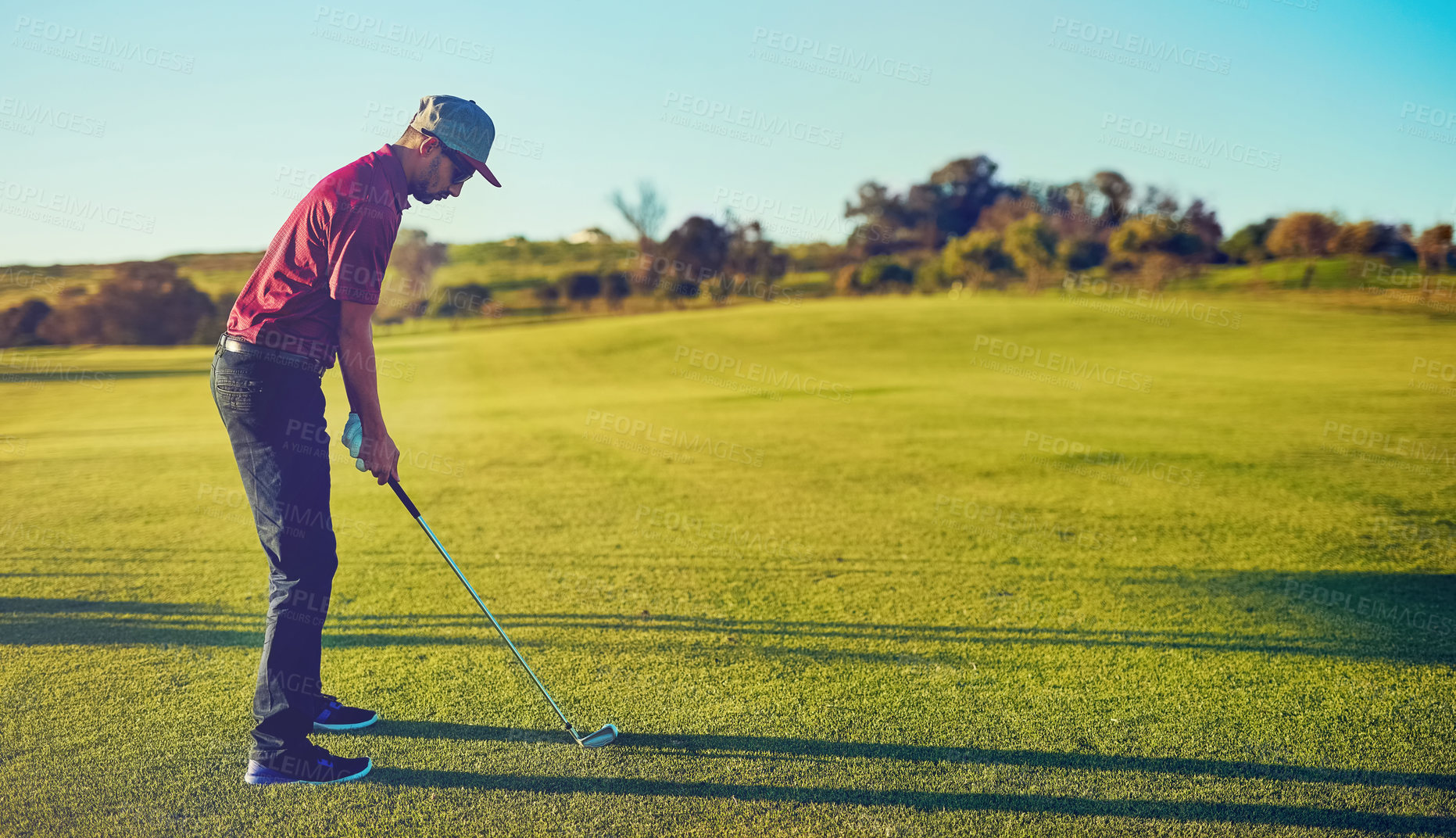 Buy stock photo Shot of a young man playing golf