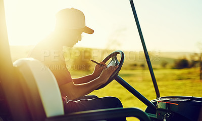 Buy stock photo Shot of a young man recording his score during a round of golf