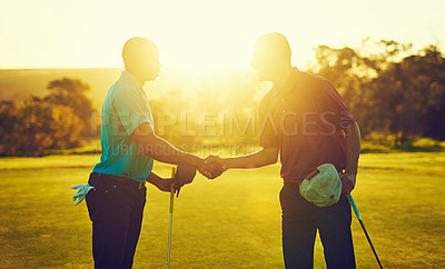 Buy stock photo Shot of two golfers shaking hands on the golf course