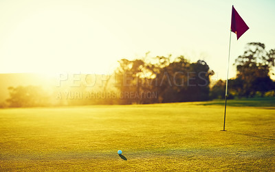 Buy stock photo Shot of a golf ball and flag on an empty course