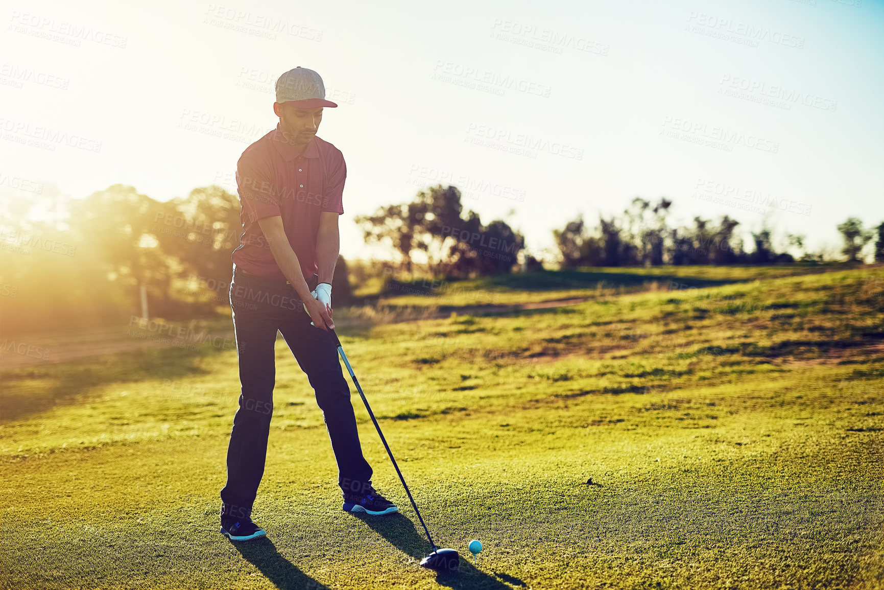 Buy stock photo Shot of a young man playing golf