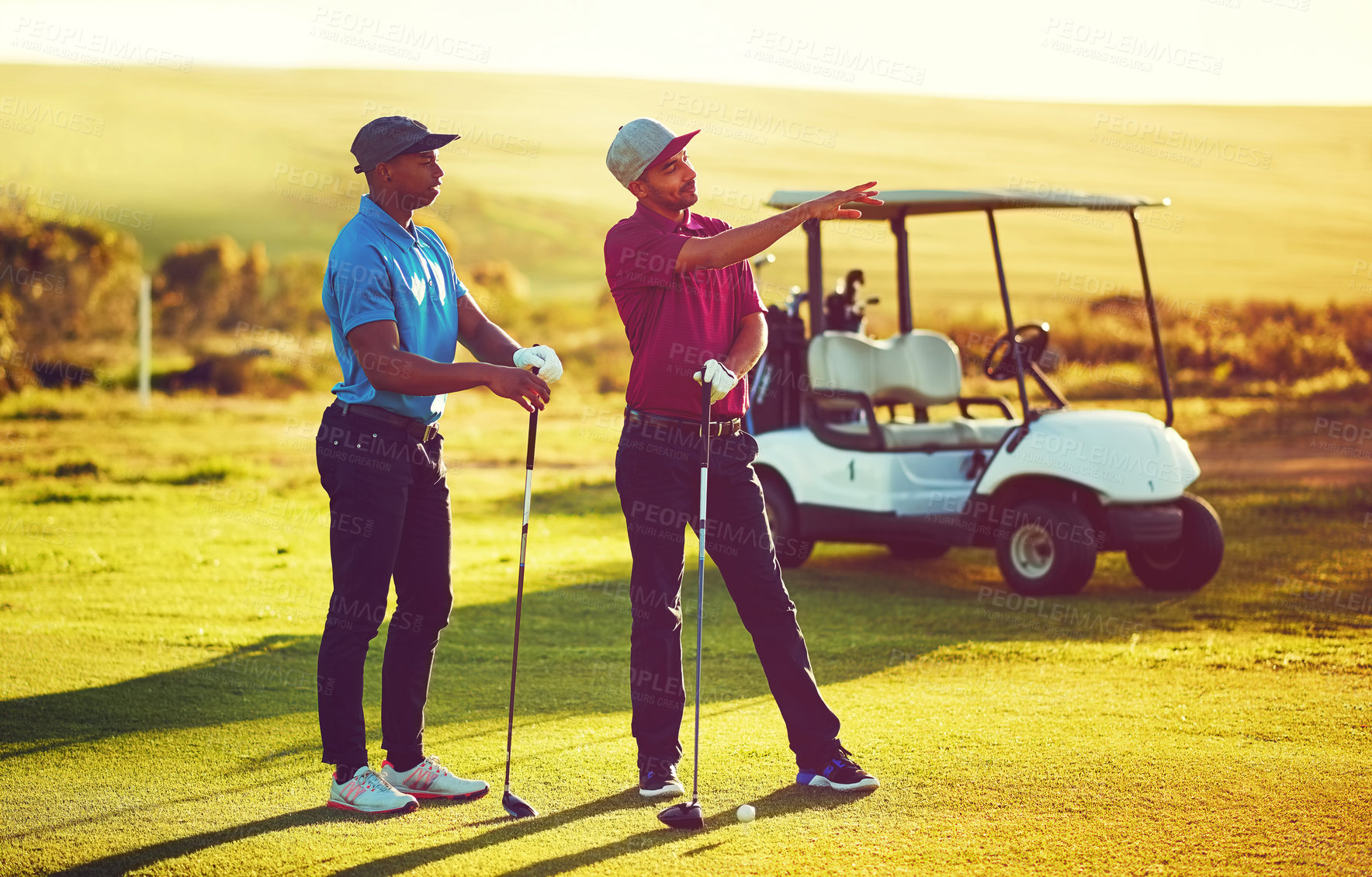 Buy stock photo Shot of two friends playing a round of golf out on a golf course