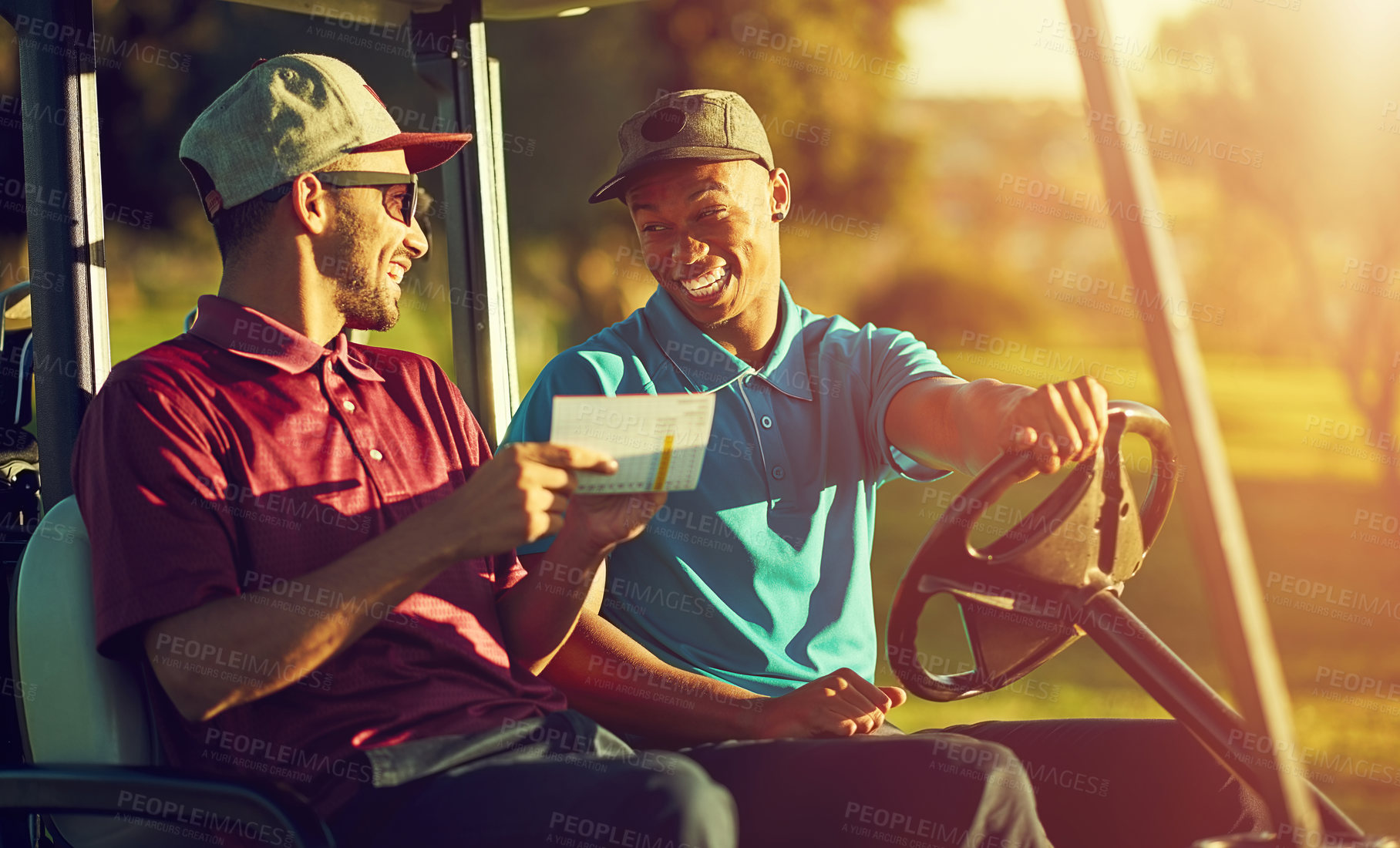 Buy stock photo Shot of two golfers riding in a cart on a golf course