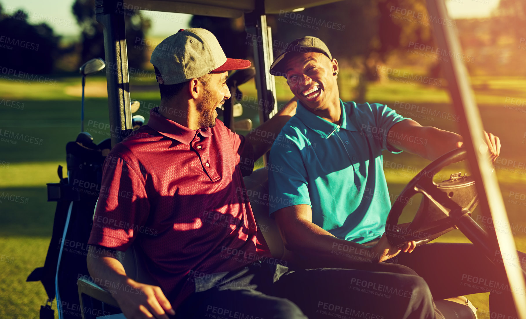 Buy stock photo Shot of two golfers riding in a cart on a golf course