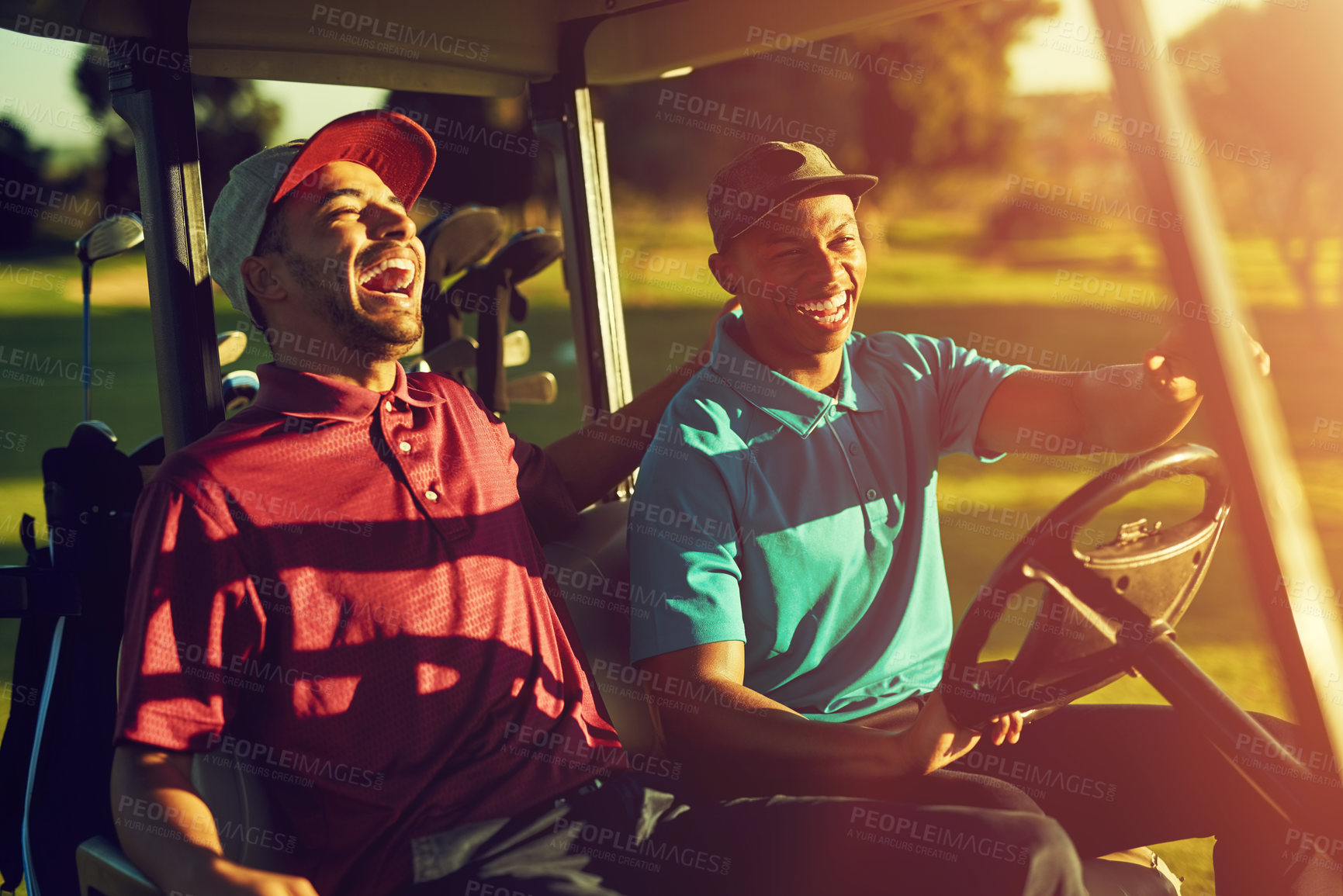 Buy stock photo Shot of two golfers riding in a cart on a golf course