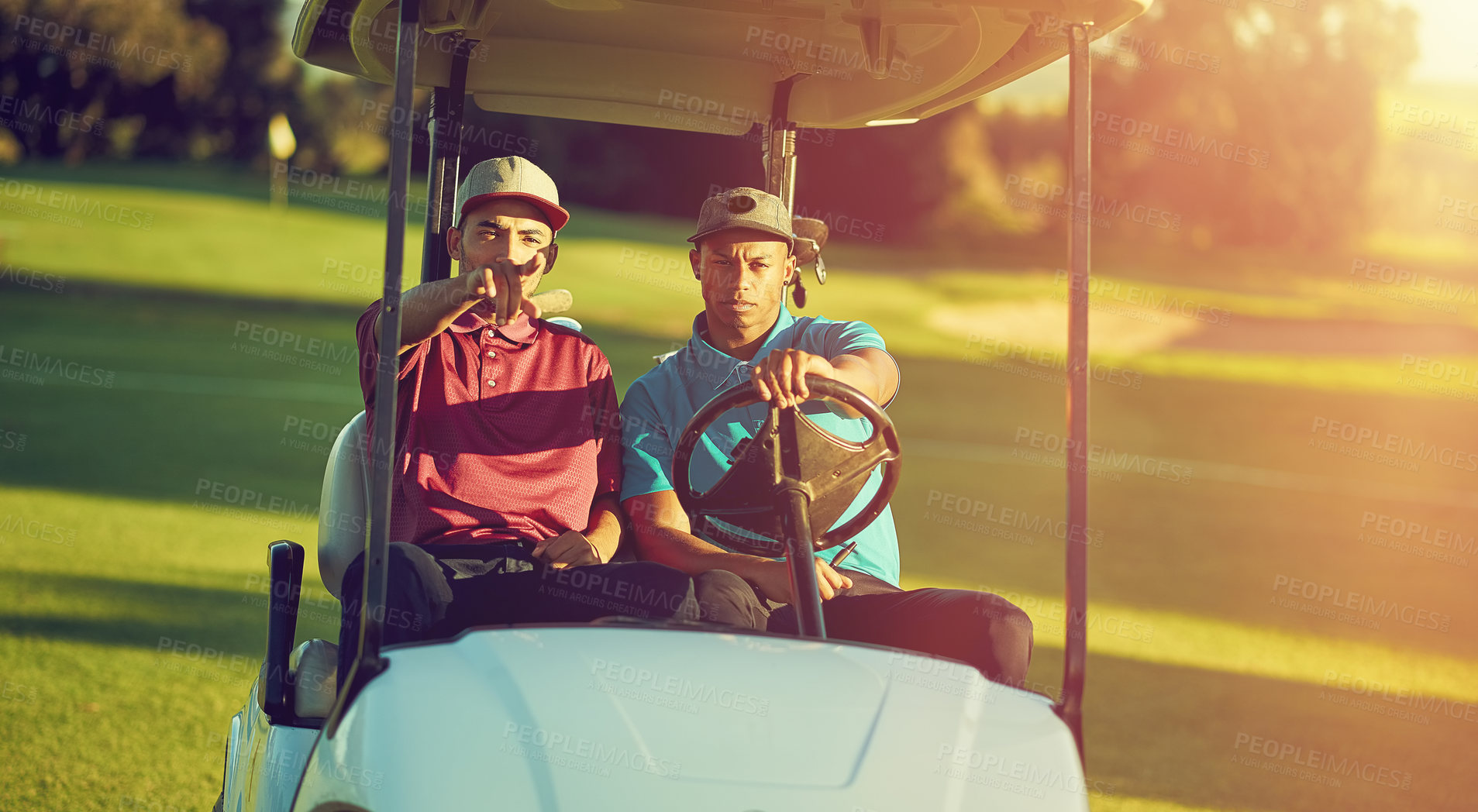 Buy stock photo Shot of two golfers riding in a cart on a golf course