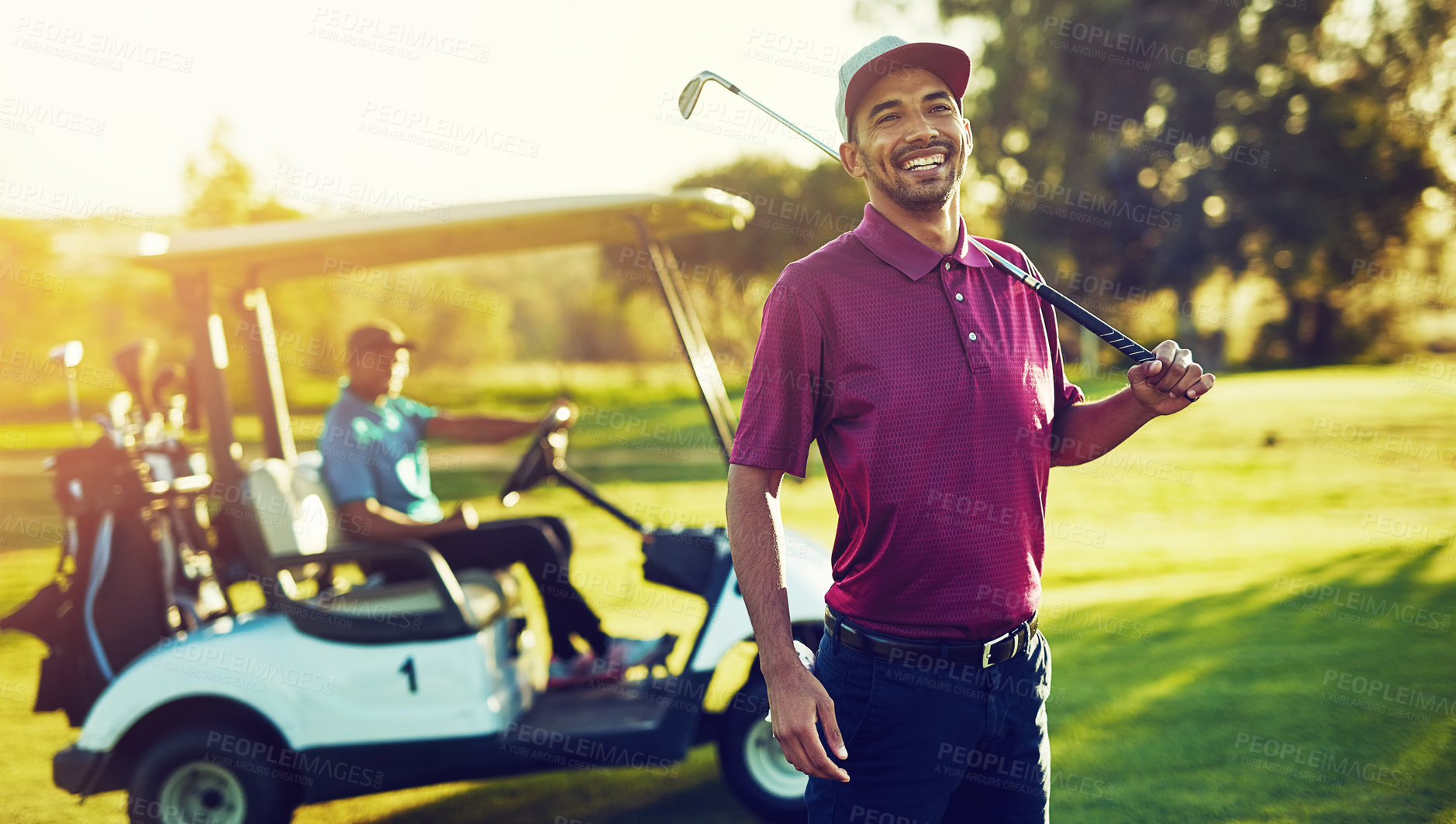 Buy stock photo Portrait of a golfer holding his club  with a buggy blurred in the background