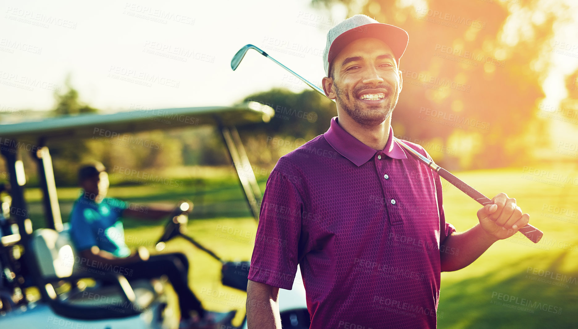 Buy stock photo Portrait of a golfer holding his club  with a buggy blurred in the background