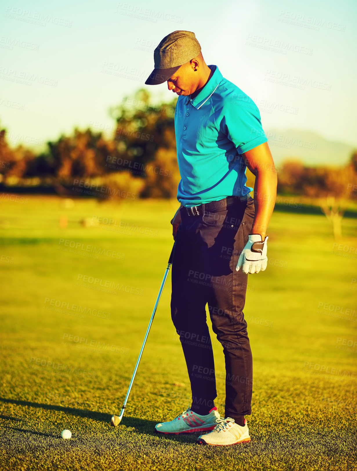 Buy stock photo Shot of a young man playing golf