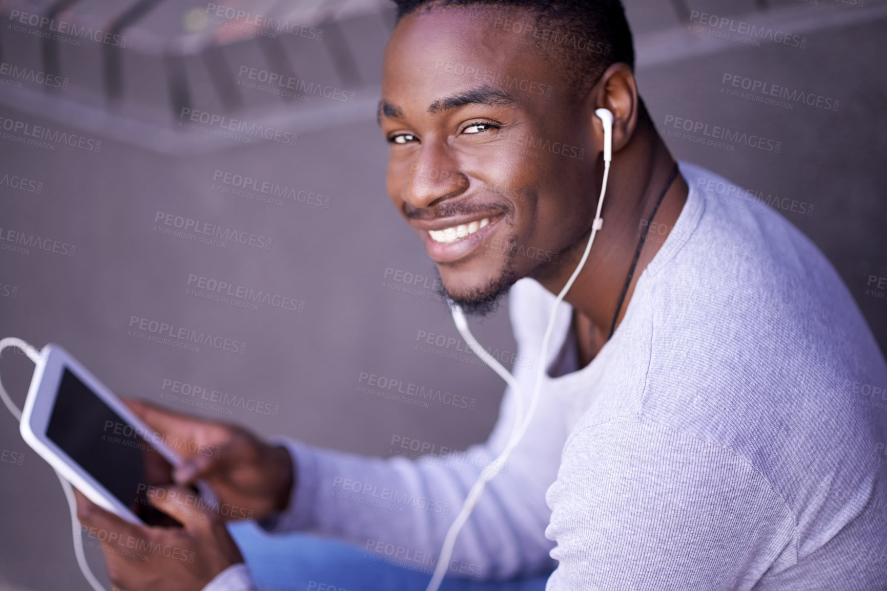 Buy stock photo Tablet, music and portrait of happy black man online for streaming audio, sound or social media  app outdoor. Face, smile and earphones for listening to radio, tech and scroll on website in Kenya