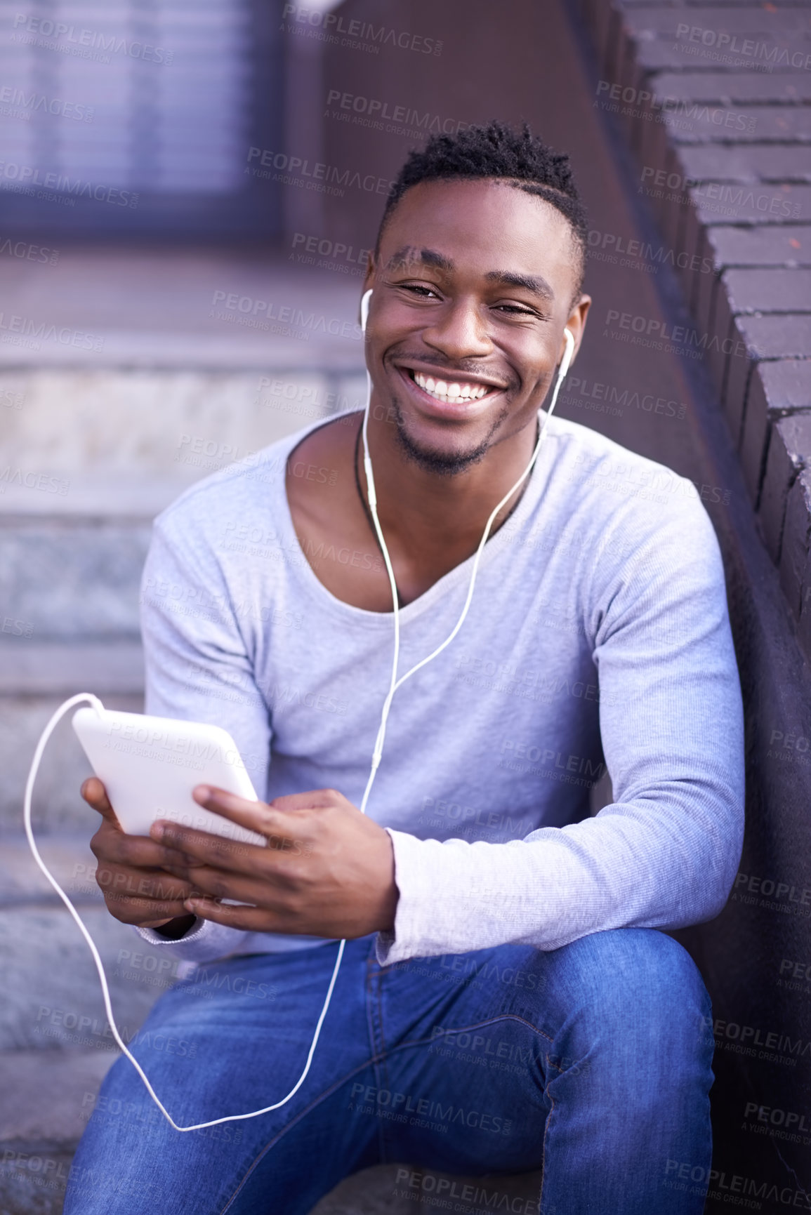 Buy stock photo Black man, portrait and earphones or technology for music in city or sitting on steps, streaming or connection. Male person, social media and texting or downtown in Atlanta, relax or subscription