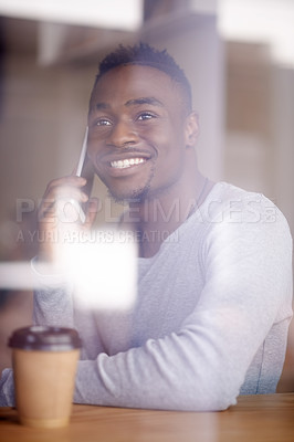 Buy stock photo Cafe, smile and black man with phone call by window for contact, communication and networking. Happy, male person and thinking in coffee shop with tech for planning, discussion and conversation