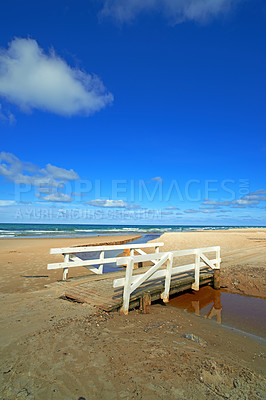 Buy stock photo Ocean beach, wood bridge and blue sky for travel, holiday destination and location for summer vacation. Sea water, sand and land for tourism, adventure and waves in horizon on tropical island in Bali