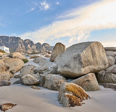 Buy stock photo Background, rocks and blue sky as landscape, coast and view by beach as wallpaper, nature and travel. Textures, earth and mountain as tropical island for vacation, holiday or destination in Indonesia