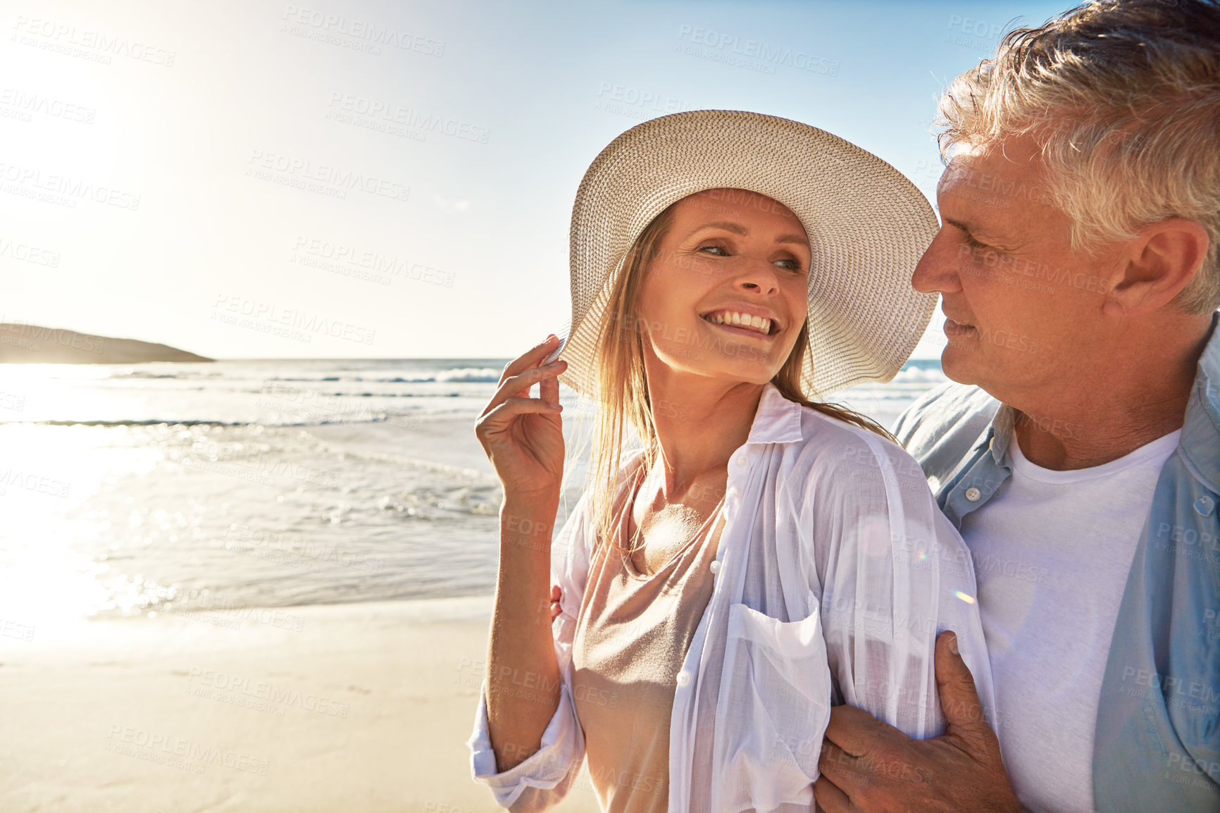 Buy stock photo Senior, happy couple and beach with love in sunset for embrace, hug or bonding together in nature. Man, woman or lovers with smile for outdoor sunshine, summer or holiday by water, sea or ocean coast