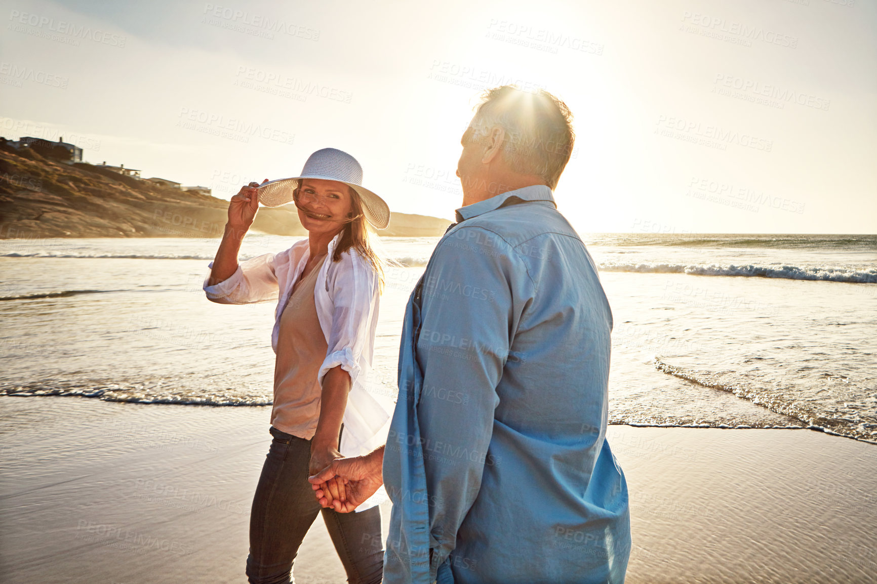 Buy stock photo Couple, walk and holding hands on beach for vacation on island or coast for getaway, travel and holiday. Happy woman, man and relationship for love or marriage anniversary by ocean at sunrise in Bali