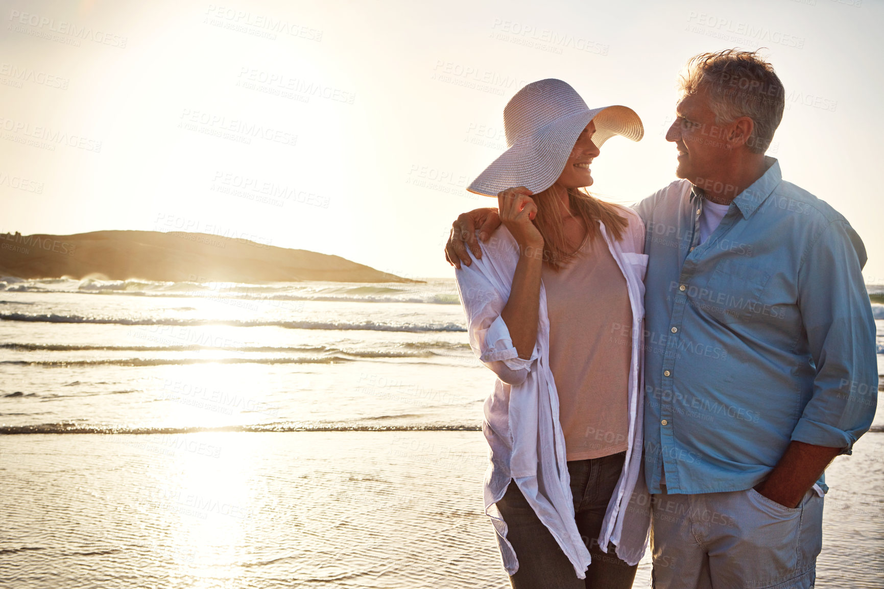 Buy stock photo Senior, happy couple and hug with beach sunset for love, embrace or bonding together in nature. Man, woman or lovers with romance on outdoor summer holiday by water, sea or ocean coast in sunshine