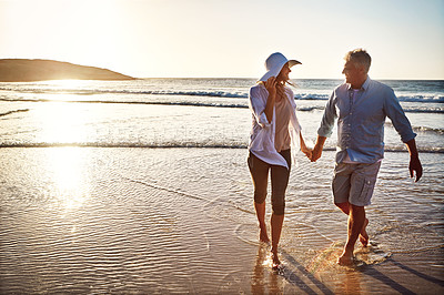 Buy stock photo Shot of a mature couple spending the day at the beach