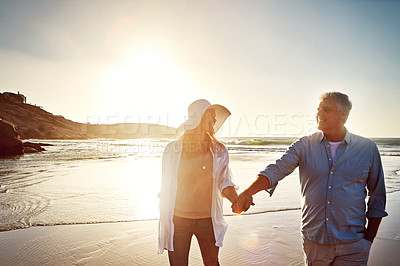 Buy stock photo Shot of a mature couple spending the day at the beach