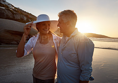 Buy stock photo Mature, happy couple and walking with hug on beach sunset for embrace, love or bonding in nature. Man, woman or lovers enjoying romance, support or outdoor holiday for summer by water or ocean coast