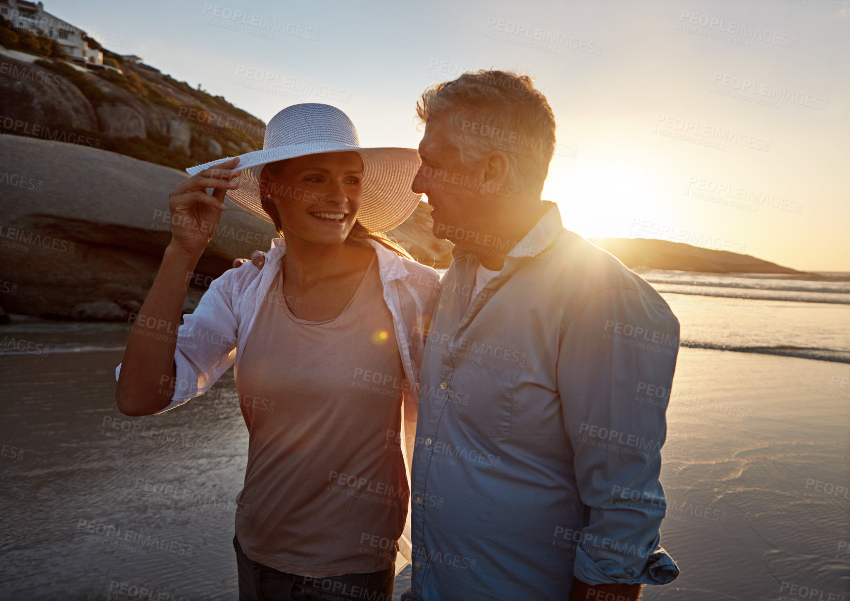 Buy stock photo Mature, happy couple and walking with hug on beach sunset for embrace, love or bonding in nature. Man, woman or lovers enjoying romance, support or outdoor holiday for summer by water or ocean coast