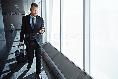 Buy stock photo Business man, phone and texting in airport for smile, luggage or email notification on international travel. Entrepreneur, bag or smartphone for flight schedule, global immigration or idea in London